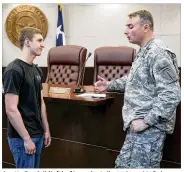  ?? JAY JANNER / AMERICAN-STATESMAN 2015 ?? Austin Cordell (left) of Leander talks to Army Lt. Col. Mark Lastoria of the Special Operations Command in April 2015 after a public hearing about the Jade Helm 15 military training exercise in Bastrop County. An overflow crowd came to the hearing in...