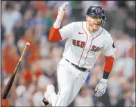  ?? Michael Dwyer The Associated Press ?? Trevor Story flips his bat after hitting a grand slam in the third inning of the Red Sox’s 7-3 victory over the Mariners at Fenway Park.