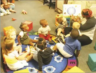  ?? Brodie Johnson • Times-Herald ?? Children are spending time inside today at daycares while rain falls throughout the Delta. Teva Hamilton reads the book "I Wonder Why the Stars Twinkle" this morning to the younger children at a local daycare.