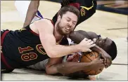  ?? RON SCHWANE - THE ASSOCIATED PRESS ?? Matthew Dellavedov­a ties up the 76ers’ Shake Milton for a jump ball April 1at Rocket Mortgage FieldHouse.