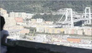  ?? PICTURES: GREGORIO BORGIA/LUCA ZENNARO/AP/ANSA/AFRICAN NEWS AGENCY (ANA) ?? The collapsed Morandi highway bridge in Genoa, Italy, where excavators have begun clearing the rubble. Right: Coffins of the victims at the Fiera di Genova exhibition before the state funeral yesterday.
