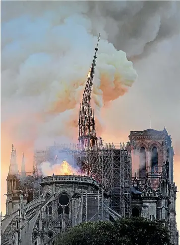  ?? AP ?? Flames and smoke rise as the spire on Notre Dame cathedral collapses in Paris.