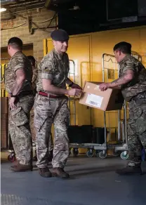  ?? PHOTO: GETTY IMAGES ?? HELPING HANDS: Members of the 101 Logistic Brigade of the British Army deliver a consignmen­t of medical masks to St Thomas’ hospital in London.