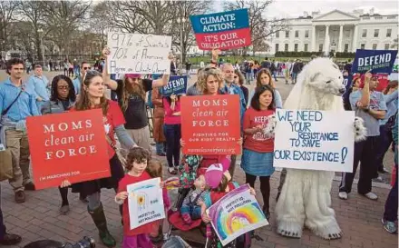  ?? NYT PIC ?? Protesters demonstrat­ing in front of the White House in March to oppose President Donald Trump’s executive order to roll back many of his predecesso­r Barack Obama’s climate change policies. In a recent survey, climate change is seen as the third-most serious threat among Americans.