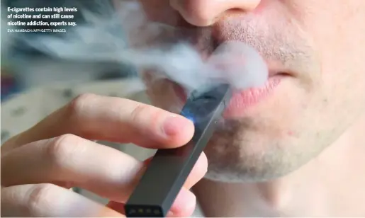  ?? EVA HAMBACH/AFP/GETTY IMAGES ?? E-cigarettes contain high levels of nicotine and can still cause nicotine addiction, experts say.
