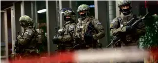  ?? AP ?? GERMAN special police stand in front of the Munich, southern Germany, main train station on Dec. 31, after police warned of “imminent threat” of terror attack.