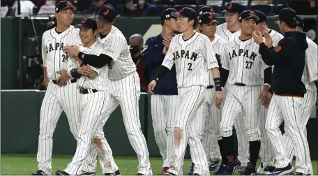  ?? AP PHOTO/EUGENE HOSHIKO ?? Shohei Ohtani, third from left, and his teammates celebrate after winning against China after their Pool B game at the World Baseball Classic (WBC) at the Tokyo Dome Thursday, March 9, 2023, in Tokyo.