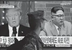  ?? AFP ?? ▪ A South Korean soldier walks past a TV screen showing pictures of US President Donald Trump (L) and North Korean leader Kim Jong Un, Seoul, March 9