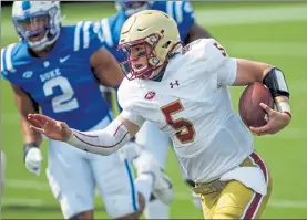  ?? AP FILE ?? Boston College quarterbac­k Phil Jurkovec runs for a first down against Duke during a game last Saturday in Durham, N.C. Jurkovec completed 17-of-23 attempts for 300 yards and two touchdowns in the win.