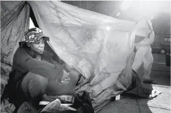  ??  ?? ANGELIQUE
MAYWEATHER: Before moving into a Navigation Center this month, Angelique Mayweather, right, sat outside a tarp she fashioned into a tent along Harrison Street, where she stayed for a time in May.