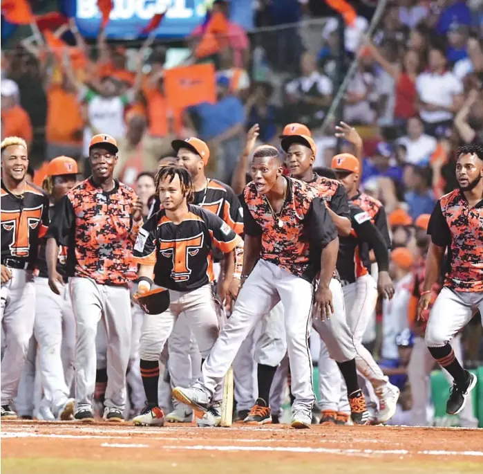  ?? GLAUCO MOQUETE ?? Jugadores de los Toros del Este celebran luego del out 27 que le dio la victoria y la corona, la tercera para el equipo romanense.