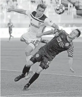  ?? [PHOTO BY BRYAN TERRY, THE OKLAHOMAN] ?? Oklahoma City’s Christian Volesky, right, and Fresno’s Sam Strong go for the ball during a USL soccer game between the Oklahoma City Energy FC and Fresno FC at Taft Stadium on Wednesday night.