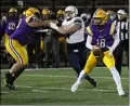  ?? RANDY MEYERS — FOR THE MORNING JOURNAL ?? Avon quarterbac­k Niko Pappas scrambles away from the Hoban defense during the first quarter on Nov. 13 at Byers Field in Parma.