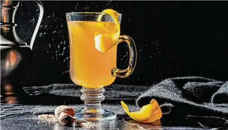  ?? Photos by Scott Suchman/for the Washington Post ?? To get the full effect of a Honeyed Hot Toddy, be sure to serve with grated nutmeg and a lemon peel.