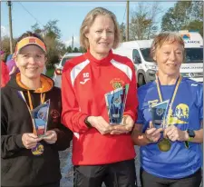  ??  ?? Susanne Foley, Selena Nolan-Culligan and Geraldine O’Sullivan with their awards after taking part in the annual Run Ballymac event on Sunday.