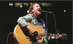  ?? JOHN J. KIM/CHICAGO TRIBUNE ?? Eddie Vedder of Pearl Jam performs solo in 2023. The band will release a new album, “Dark Matter,” in April and embark on a tour in May.