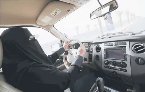  ??  ?? A Saudi woman, Amira, who works in Aramco, drives to work in Dammam, Saudi Arabia. — Reuters photo