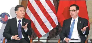  ?? YURI GRIPAS / REUTERS ?? Vice-Premier Wang Yang and US Treasury Secretary Steve Mnuchin talk before the China-US Comprehens­ive Economic Dialogue, where they discussed economic and trade issues in Washington.