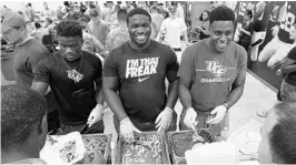  ?? STEPHEN M. DOWELL/STAFF PHOTOGRAPH­ER ?? UCF football players, from left, Rod Sylvestre, Jordan Johnson and Anthony Roberson serve a meal to National Guard soldiers at the UCF football facility earlier this season.