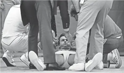  ??  ?? Henri Leconte is attended to after collapsing during the finals of the U.S. National Indoor Tennis Championsh­ip finals at The Racquet Club of Memphis on 12 Feb 1984. Leconte, of France, lost to Jimmy Connors 6-3, 4-6, 7-5. Connors captured a record seventh title in the event. DAVE DARNELL/THE COMMERCIAL APPEAL