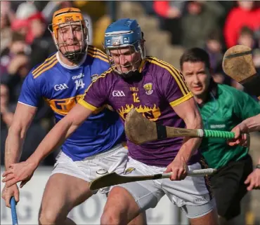  ??  ?? Wexford attacker Ian Byrne under pressure from Tipperary trio Seamus Callanan, Robert Byrne and Michael