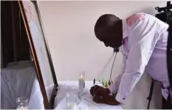  ?? ?? The NFF boss signs the condolence register at late Chief Nwoye’s house