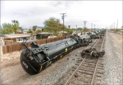  ?? PHOTO VINCENT OSUNA ?? Railroad cars, which became derailed Monday night, rest on their side just east of North Eighth Street on Tuesday morning in El Centro.