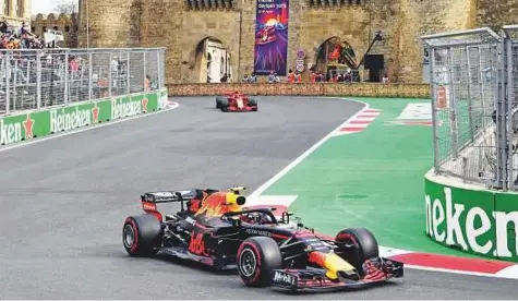  ?? AFP ?? Red Bull’s Max Verstappen ahead of Ferrari’s Kimi Raikkonen during the Formula One Azerbaijan Grand Prix in Baku on Sunday. The race through castle-walled city streets of Baku was a throwback to F1 classics and had fans on the edge of their seats.