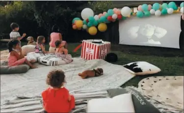  ?? ROZALYN SCHLUMPF — WITTYBASH.COM VIA AP ?? This photo provided by Wittybash.com shows children at a backyard birthday party watching the movie “Shrek” on an outdoor theater setup in Concord.