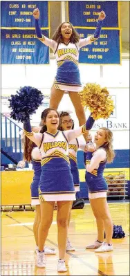  ?? Westside Eagle Observer/MIKE ECKELS ?? Mayra Flores (front) helps Desi Meek (top) lead students in a cheer during the colors day pep rally on Dec. 15. Forming the base of the elevator are Emme Lee (left), Kaitlyn Smith and Tabitha Tilley.