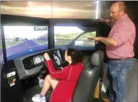 ?? PHOTOS BY MIKE URBAN — MEDIANEWS GROUP ?? Schuylkill Valley High School student Cassidy Smith in the Pennsylvan­ia DUI Safety Simulator at her school May 13as local State Farm agent Sean Reali guides her.