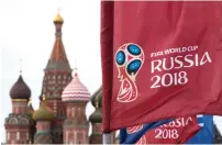  ?? — AP ?? A flag with the logo of the World Cup 2018 on display, with the St Basil’s Cathedral in the background, in Moscow.