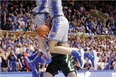  ?? AP Photo/Gerry Broome ?? ■ Colorado State forward Adam Thistlewoo­d (31) drives between Duke forward Joey Baker, right, and forward Javin DeLaurier during the first half Friday in Durham, N.C.
