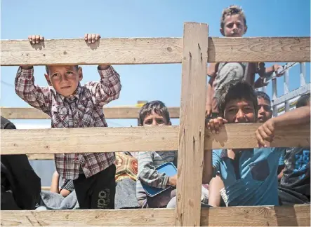  ?? — AFP ?? Save the innocents: Children looking on at a camp for displaced Palestinia­ns in Rafah, in the southern Gaza Strip, Palestine.