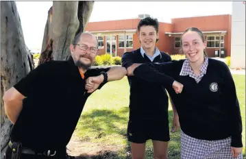  ??  ?? Wimmera Committee Against Family Violence vicechair Shane Podolski and Horsham College students William Goudie and Annabel Risson help to shine a light on violence against women. Picture: PAUL CARRACHER