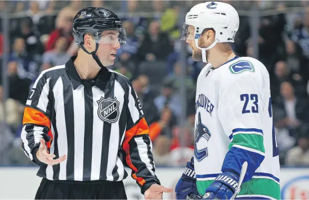  ?? — GETTY IMAGES FILES ?? Alex Edler, chatting here with referee Eric Furlatt, hasn’t been asked yet to waive his no-trade clause.