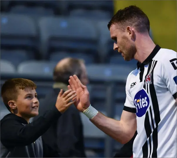  ??  ?? Ciaran Kilduff of Dundalk high fives a young fan following the SSE Airtricity League Premier Division match between Bohemians and Dundalk at Dalymount Park.