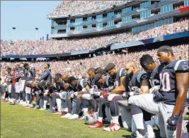  ?? Michael Dwyer ?? Associated Press Several New England Patriots players kneel during the national anthem before their game against the Houston Texans Sunday.