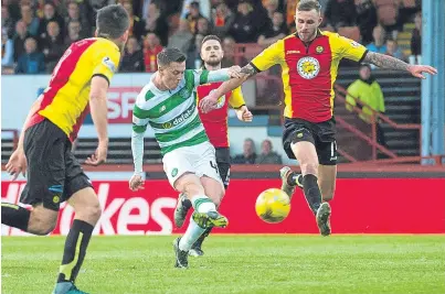  ?? Picture: SNS. ?? Callum McGregor fires home the fourth goal in Celtic’s emphatic win over the Jags.