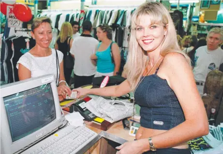  ?? ?? City Beach Surf Shops Gold Coast area manager Vicki Chalaley helps customers on the opening day of Harbour Town in November 1999. (Below left) An artist’s impression of Westfield Helensvale and (below right) Westfield chief operating officer Robert Jordan gets to work.