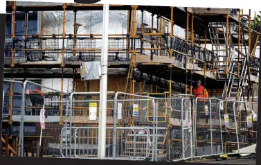  ??  ?? Return: Constructi­on workers on a site in Motherwell, Lanarkshir­e, yesterday