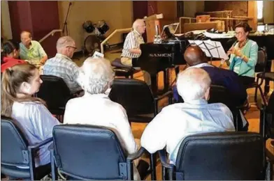  ?? PHOTOS CONTRIBUTE­D BY RESPITE CARE ATLANTA ?? Volunteer music team leader Hamilton Smith on the piano joins volunteer and oboist Jean Russ at Respite Care Atlanta. Music is a big part of RCA. Music memory persists, and members recall tunes from their youth and sing along.