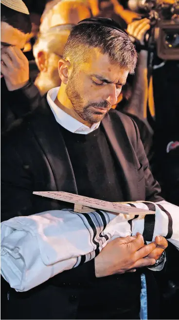  ?? MENAHEM KAHANA /AFP / GETTY IMAGES ?? Relatives of Israeli couple Amichai and Shira Ish-Ran attend the funeral of their baby, who died after being delivered prematurel­y after a drive-by shooting in the West Bank. The baby’s mother Shira was one of the seven people wounded in the attack.