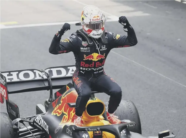  ??  ?? 0 Max Verstappen jumps out of his car as he celebrates winning the Monaco Grand Prix. The Red Bull driver is now four points clear of Lewis Hamilton in the standings