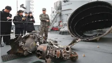  ??  ?? Objects believed to be debris from a North Korean rocket are displayed on a South Korean Navy ship at the Second Fleet Command of Navy in Pyeongtaek, south of Seoul, on Thursday. Three pieces of what seems to have been the rocket’s combustion gas jet...