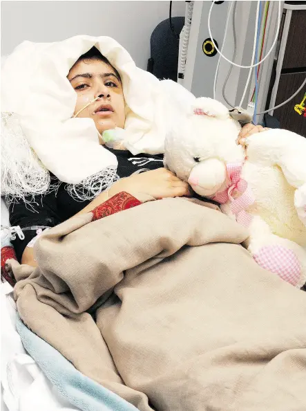  ?? AFP / QUEEN ELIZABETH HOSPITAL / UNIVERSITY HOSPITALS BIRMINGHAM / FILES ?? Malala Yousafzai lies in bed after receiving treatment at a hospital in Birmingham. The 2014 Nobel Peace Prize went to the then-17-year- old Pakistani and India’s Kailash Satyarthi for promoting children’s rights.