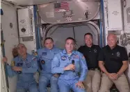  ?? ASSOCIATED PRESS ?? This photo provided by NASA shows Bob Behnken and Doug Hurley, far right, joining the the crew at the Internatio­nal Space Station, after the Spacex Dragon capsule pulled up to the station and docked Sunday, May 31, 2020. The Dragon capsule arrived Sunday morning, hours after a historic liftoff from Florida. It's the first time that a privately built and owned spacecraft has delivered a crew to the orbiting lab.