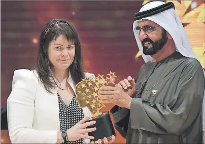  ?? CP PHOTO ?? Canadian school teacher Maggie MacDonnell receives the Global Teacher Prize from Dubai ruler Sheikh Mohammed bin Rashid Al Maktoum, in Dubai, United Arab Emirates, Sunday. MacDonnell, whose teaching philosophy underscore­s hope and acts of kindness in...