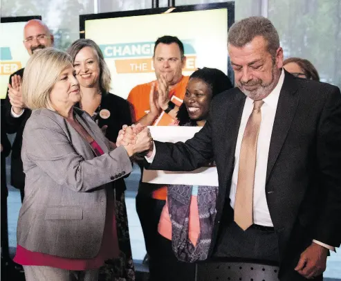  ?? MARTA IWANEK / THE CANADIAN PRESS ?? Ontario NDP Leader Andrea Horwath shakes hands with Elementary Teachers’ Federation of Ontario president Sam Hammond during a campaign event in Toronto on Thursday. The union has endorsed Horwath’s New Democrats.