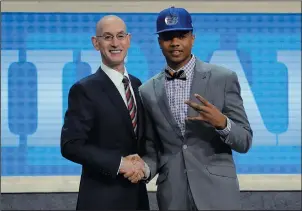  ?? AP PHOTO/ FRANK FRANKLIN II ?? Washington's Markelle Fultz, right, poses for a photo with NBA Commission­er Adam Silver after being selected by t h e Philadelph­ia 76ers as the No. 1 pick overall during the NBA basketball draft, Thursday in New York.